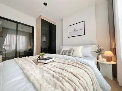 Cozy modern bedroom with elegant decor and soft lighting, perfect for relaxation and comfort.