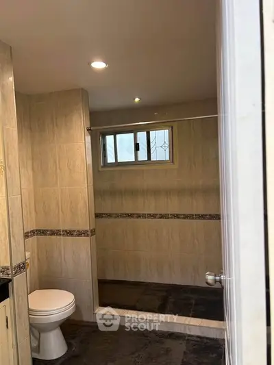 Spacious bathroom with modern fixtures and elegant tile design.