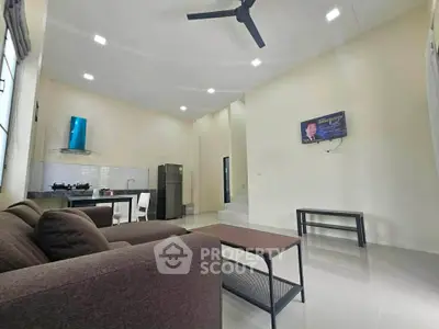 Spacious living room with modern kitchen and sleek furniture, perfect for contemporary living.
