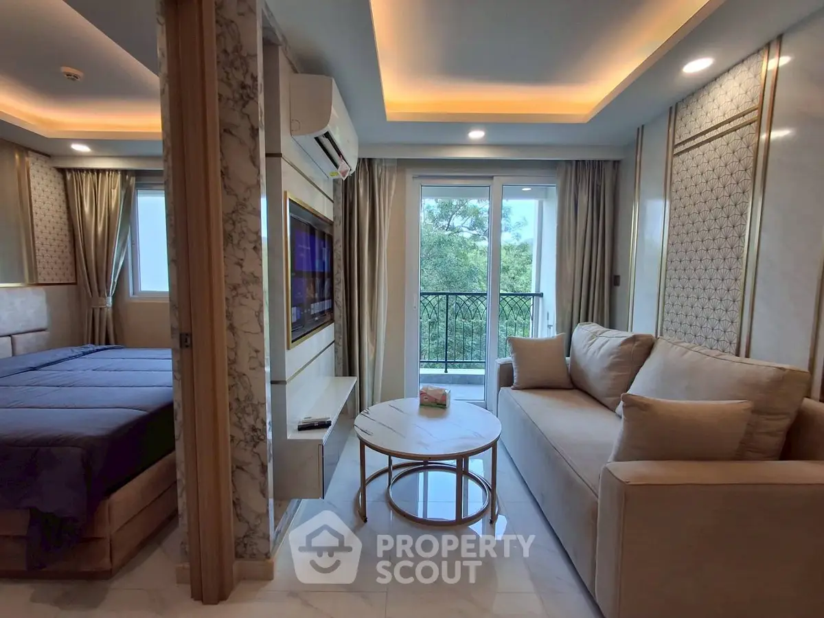 Luxurious modern living room with elegant decor and natural light, featuring a cozy sofa and a scenic balcony view.