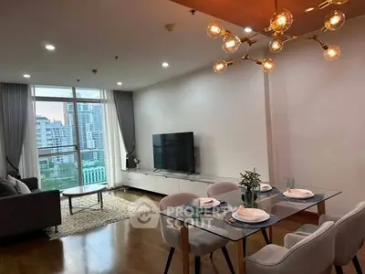Modern living room with city view, stylish lighting, and elegant dining area in a high-rise apartment.