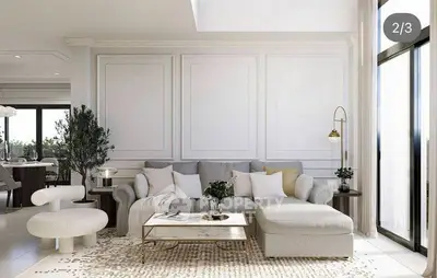 Luxurious living room with elegant decor and large windows offering natural light.