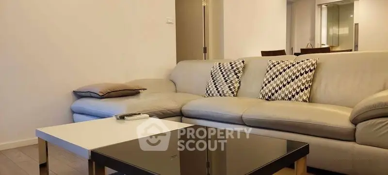 Modern living room with stylish sofa and coffee table in a cozy apartment setting.