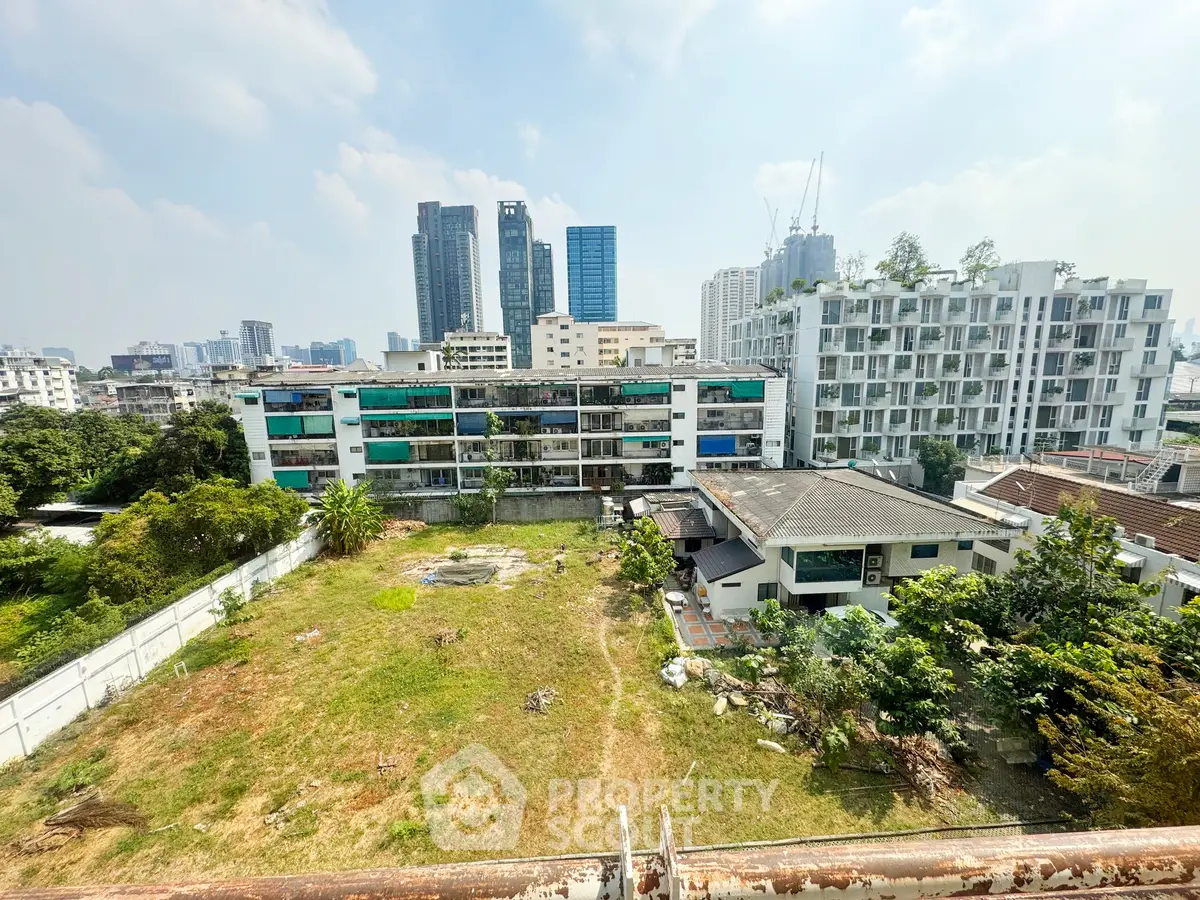 Stunning cityscape view with modern high-rise buildings and lush greenery, perfect for urban living.
