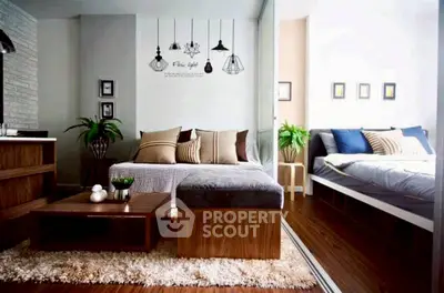 Modern living room with stylish decor and cozy bedroom in open layout apartment.