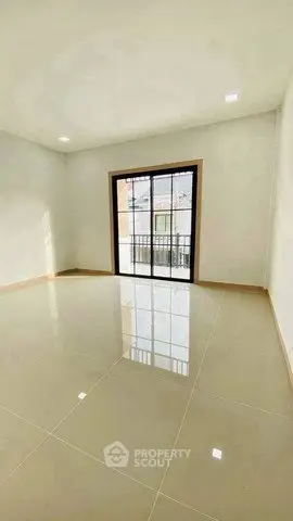 Spacious empty room with large window and glossy tiled floor, perfect for customization.