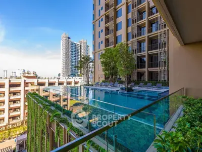 Luxurious high-rise building with stunning rooftop pool and city view, perfect for urban living.