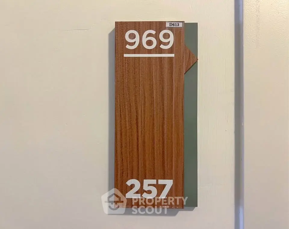 Modern apartment door number sign with wood finish and sleek design, perfect for contemporary living spaces.