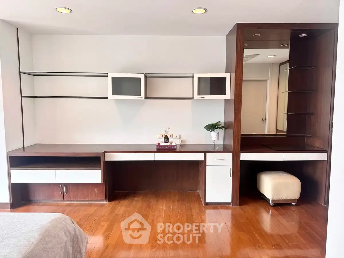Spacious study room with modern built-in desk and shelving, perfect for productivity and organization.
