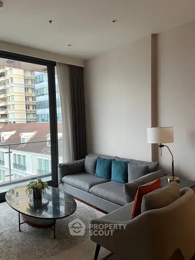 Modern living room with stylish furniture and large window offering city view