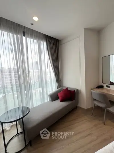 Modern bedroom with stylish chaise lounge and city view