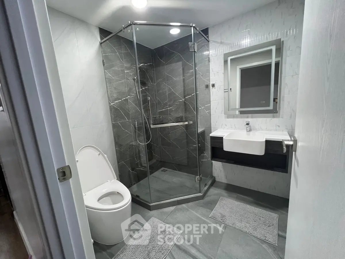 Modern bathroom with glass shower and sleek fixtures