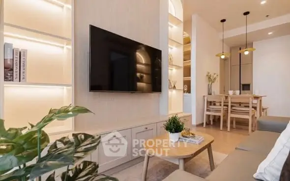 Modern living room with sleek TV setup and elegant dining area
