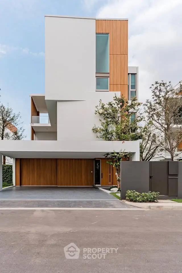 Modern minimalist house with wooden accents and large windows, showcasing contemporary architecture.