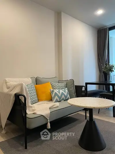 Modern living room with stylish sofa and chic decor in a cozy apartment setting.