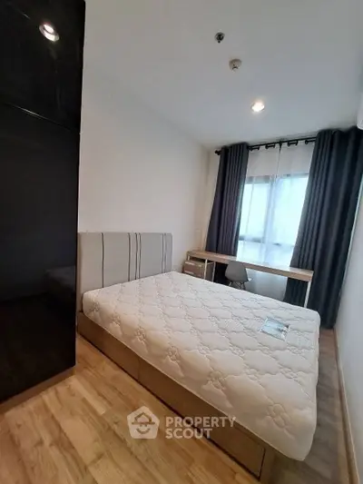 Modern bedroom with stylish decor and large window for natural light