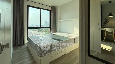 Bright bedroom with large window and city view, featuring modern decor and wooden flooring.