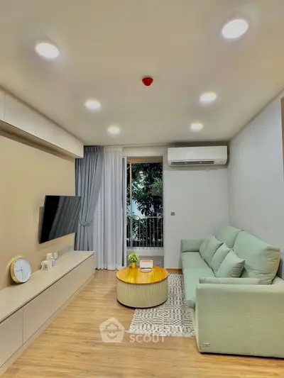 Modern living room with sleek design, featuring a cozy sofa, wall-mounted TV, and elegant lighting.