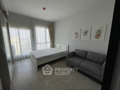 Modern bedroom with large windows and stylish decor in a high-rise apartment.