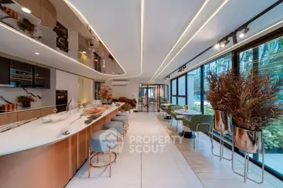 Luxurious open-layout kitchen with modern design and elegant dining area.