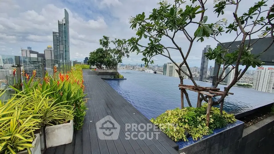 Stunning rooftop infinity pool with panoramic city views and lush greenery.