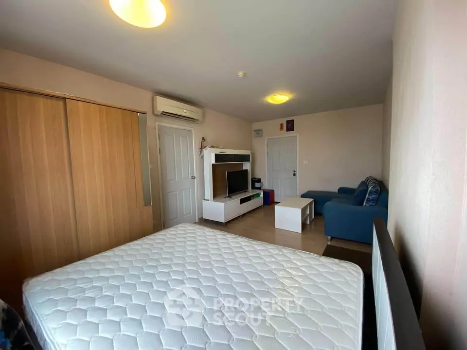 Spacious bedroom with modern furniture and ample natural light