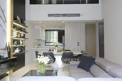 Luxurious modern living room with open kitchen and elegant decor