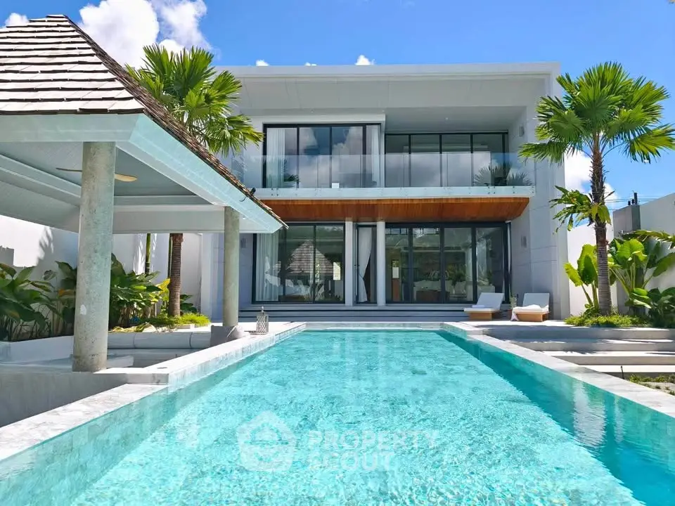Luxurious modern villa with stunning pool and tropical landscaping, perfect for upscale living.