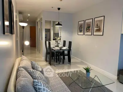 Modern living room with stylish decor and dining area in open layout apartment.