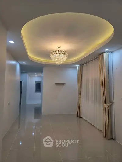 Elegant living room with chandelier and modern ceiling design