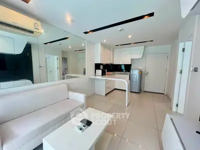 Modern open-layout living room with sleek kitchen and stylish decor