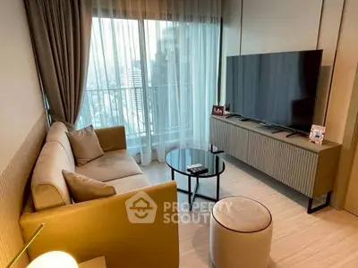 Modern living room with large TV and city view from balcony.