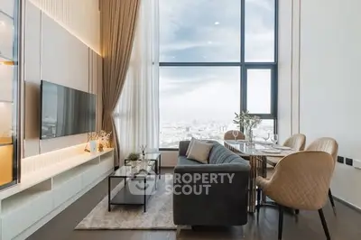 Luxurious high-rise living room with stunning city view, elegant decor, and modern furnishings.