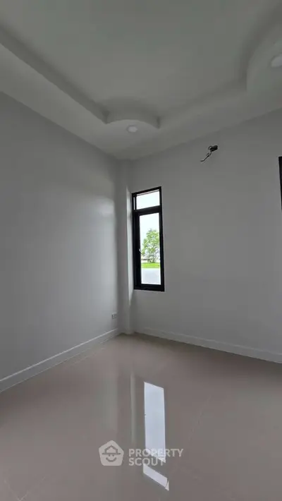 Bright empty room with large window and glossy floor tiles