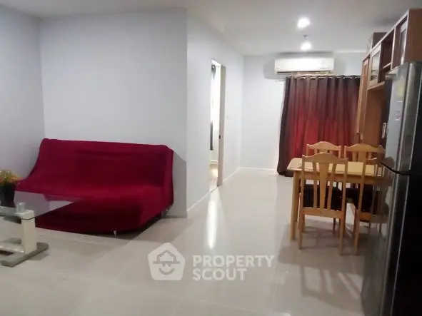 Spacious living room with modern furniture and dining area in a cozy apartment.