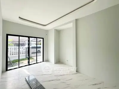 Spacious modern living room with large windows and elegant marble flooring.