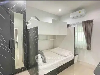 Modern bedroom with bunk bed and sleek wardrobe design