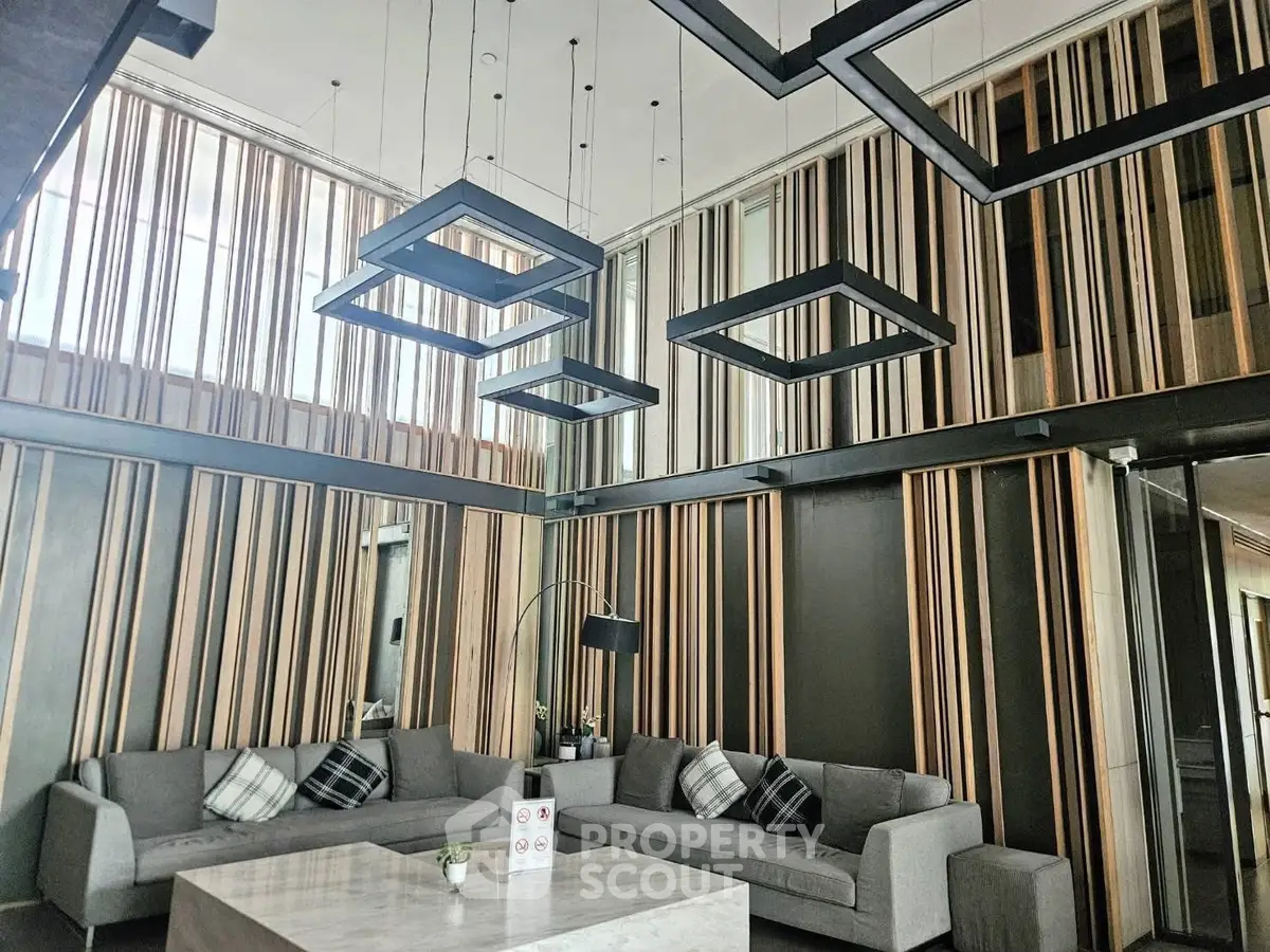 Modern living room with stylish lighting and contemporary decor in a luxury apartment.