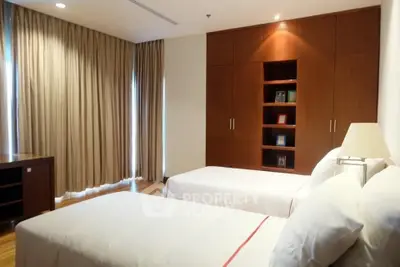 Spacious bedroom with twin beds and elegant wooden wardrobe