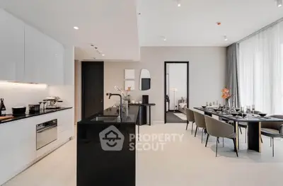 Luxurious modern kitchen and dining area with sleek design and elegant furnishings.