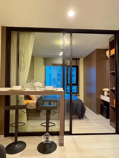 Modern studio apartment with glass partition and cozy decor