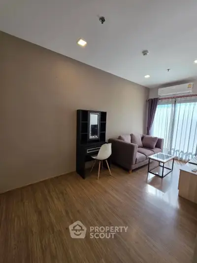 Modern living room with cozy sofa and natural light from large window