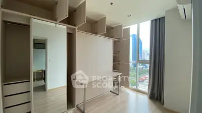 Spacious modern bedroom with built-in storage and city view