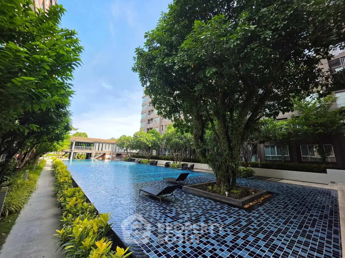 Luxurious residential pool area with lush greenery and modern design