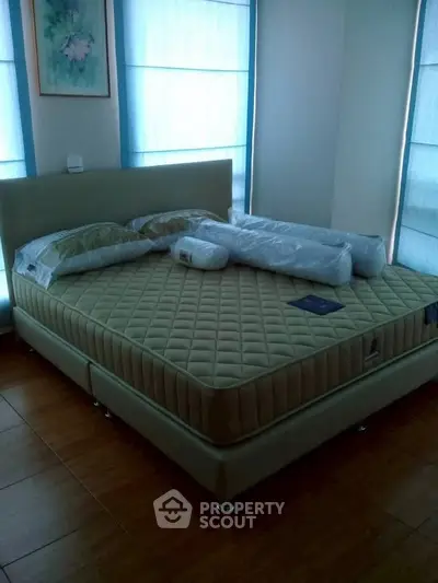 Spacious bedroom with a comfortable bed and elegant decor, perfect for relaxation and restful nights.