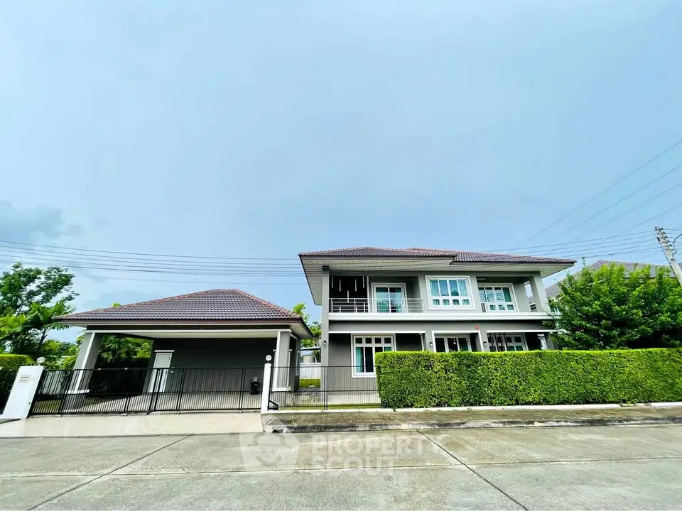 Stunning modern two-story house with lush greenery and spacious driveway