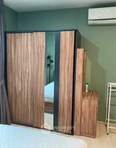 Modern bedroom with stylish wardrobe and air conditioning unit