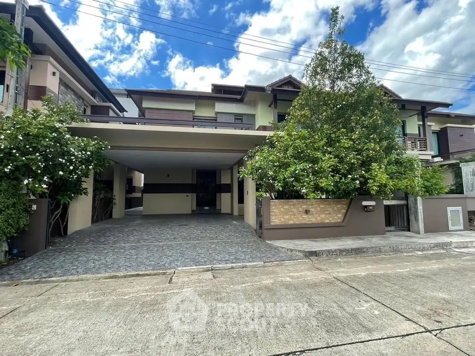Stunning modern house with spacious driveway and lush greenery in a serene neighborhood.