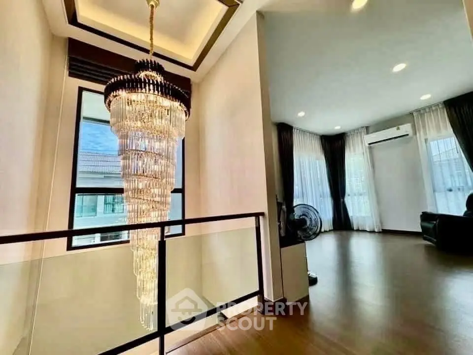 Luxurious interior with elegant chandelier and spacious living area.