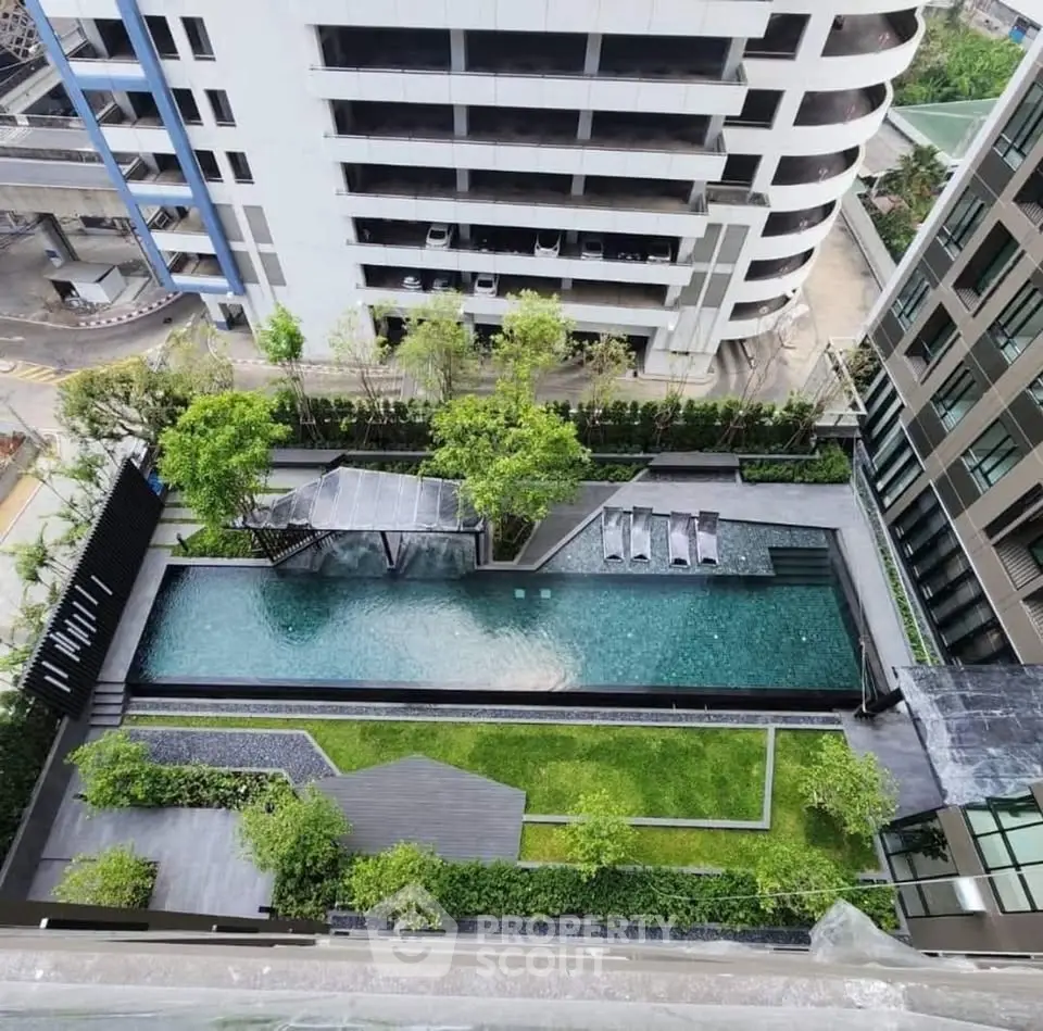 Luxurious rooftop pool with lush greenery and modern design in urban high-rise setting.